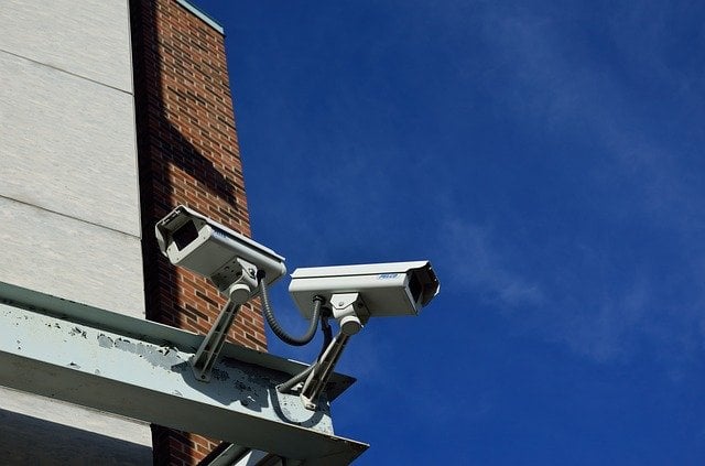 Two CCTV cameras at the corner of an office building