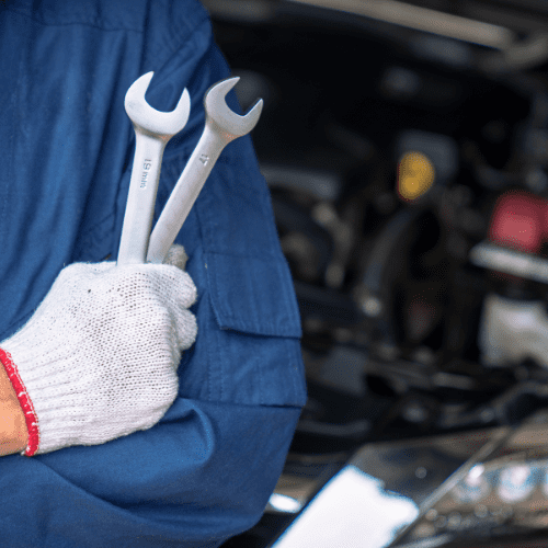 mechanic holding wrenches